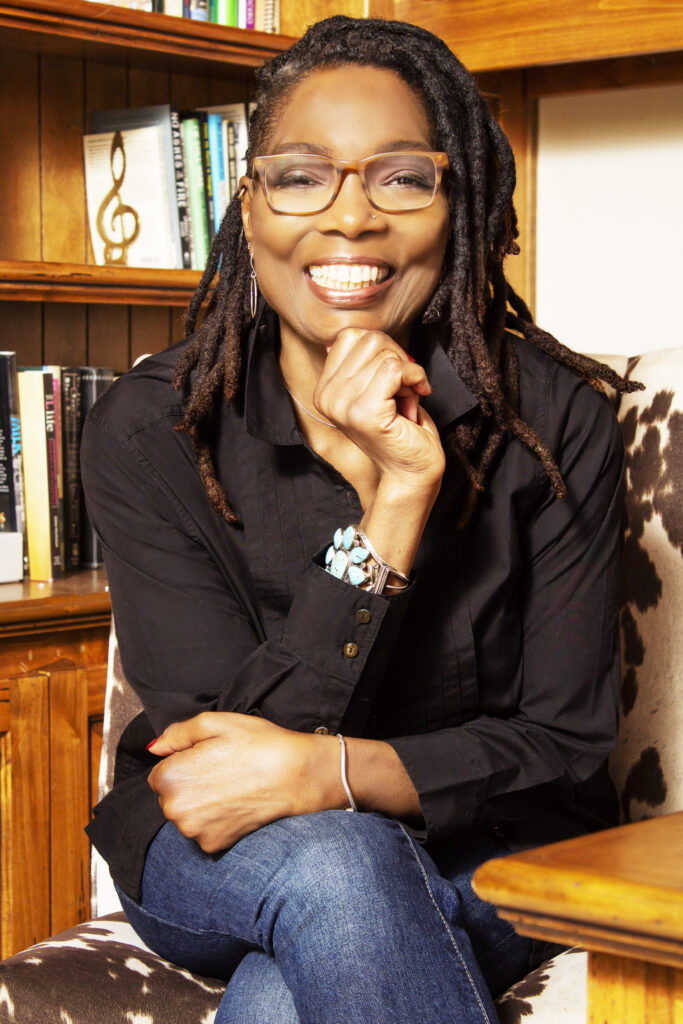 Kim Green smiling in a warm portrait for Blank Page Consulting, a Tucson business offering life coaching and writing support.