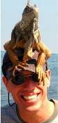 Tony Ray Baker, Tucson REALTOR®, enjoying a playful moment with an iguana on his head at a beach in Mexico