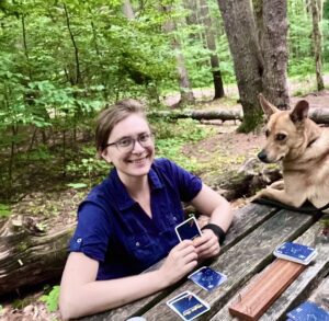 Sarah Baracks sitting at a wooden table smiling