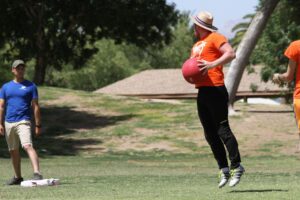 Our League Tucson player jumping with kickball in hand