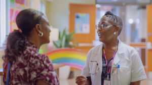 Healthcare professional at Copper Queen Community Hospital offering LGBTQ health brochures.