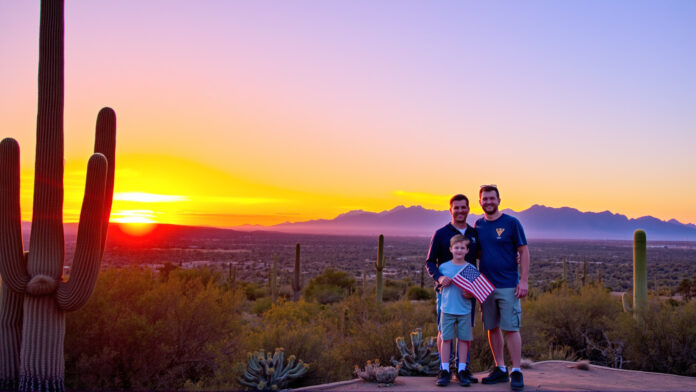 A family standing on a desert trail at sunset, surrounded by saguaro cacti and Tucson Mountains.