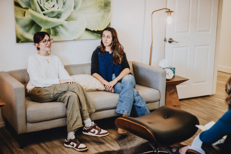 Two people seated on a couch during a therapy session at Soul Space in Tucson