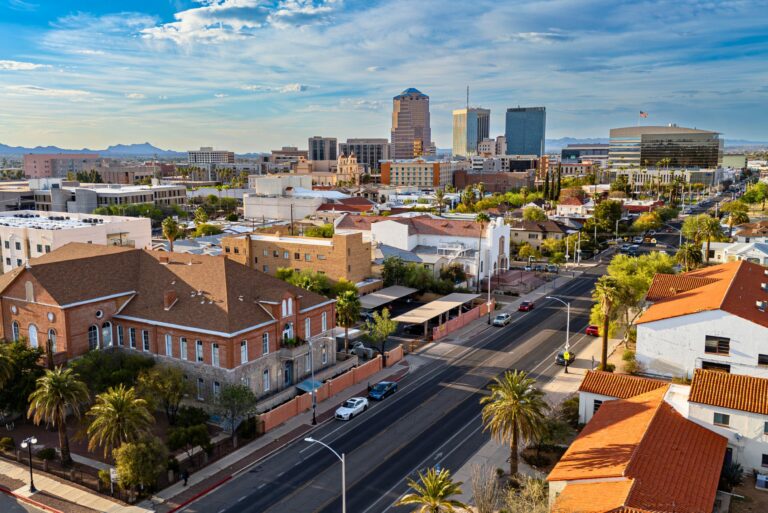 Aerial view of downtown Tucson, Arizona, with palm trees and mountains
