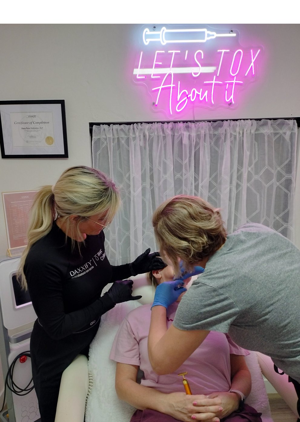 Kelley Beck administering a dermal filler treatment in a studio setting.